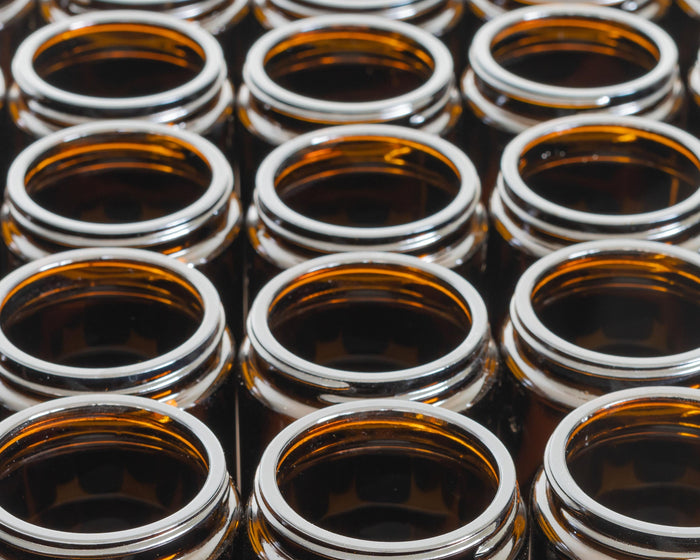 rows of empty amber glass jars